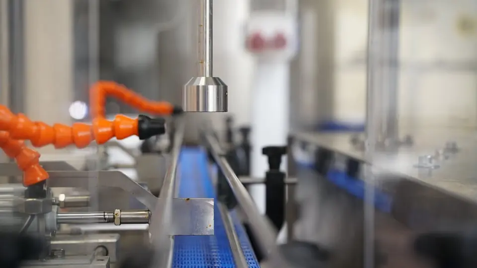 Stainless conveyor line with sensors and pneumatic components
